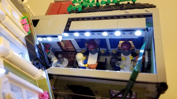 First floor of Parisian Cafe, with ribbon lighting tucked into a groove attached to the ceiling.