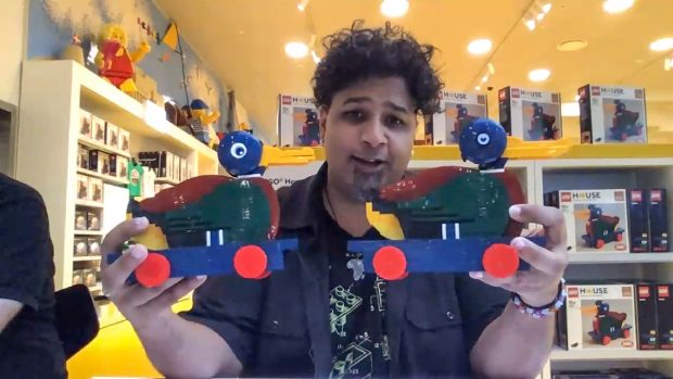 Jme Wheeler holding Stuart's prototype (left) and the final design (right).