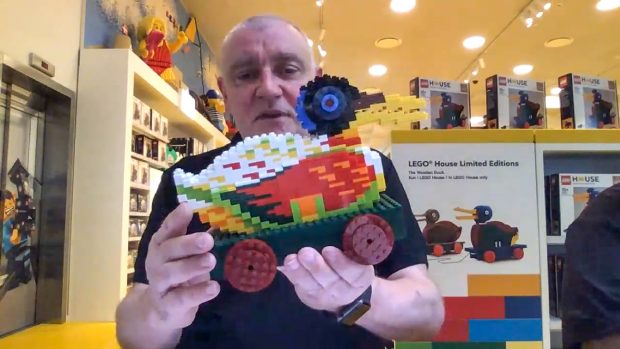 Stuart Harris holding a more colorful design prototype.