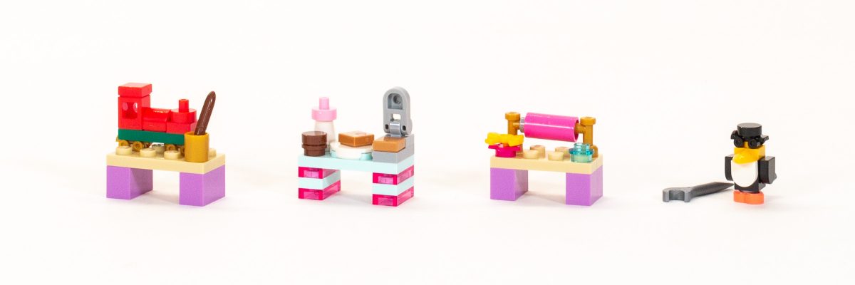 Locomotive on table, waffle making table, gift wrapping table, and wind-up penguin.