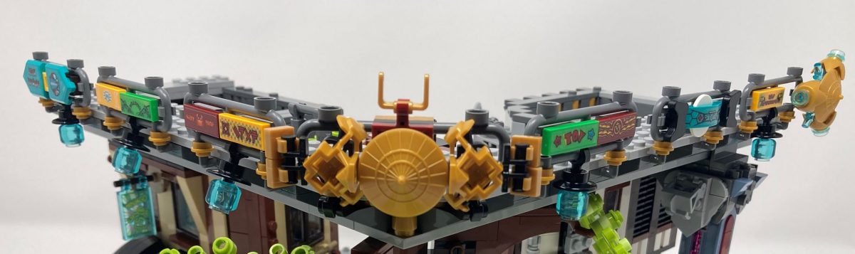 Ornaments, lanterns and signage fill the second floor walkway barriers.