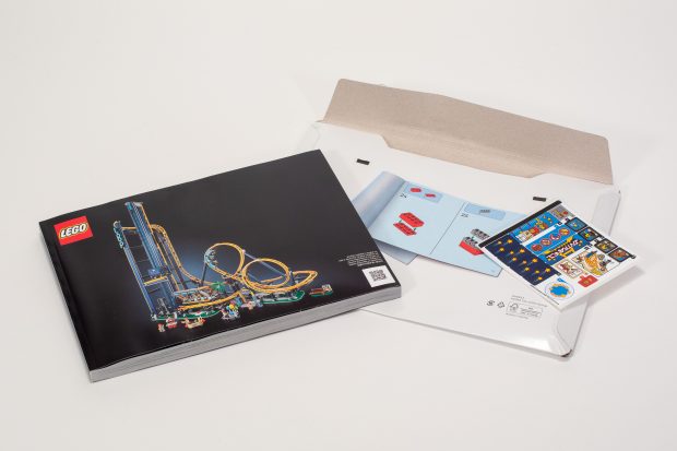 Thin cardboard pouch protecting the building instructions and sticker sheet.