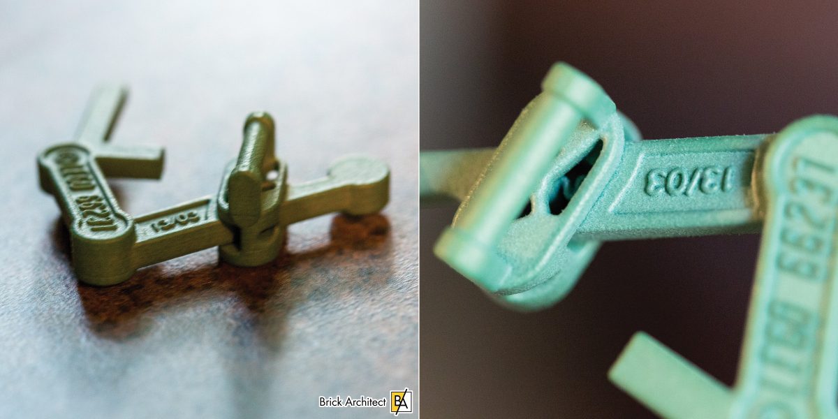 #66237 Drafting Arm was the first official 3d-printed LEGO element. It has a small "s" shaped spring that allows the arm to bend after being clipped into place.