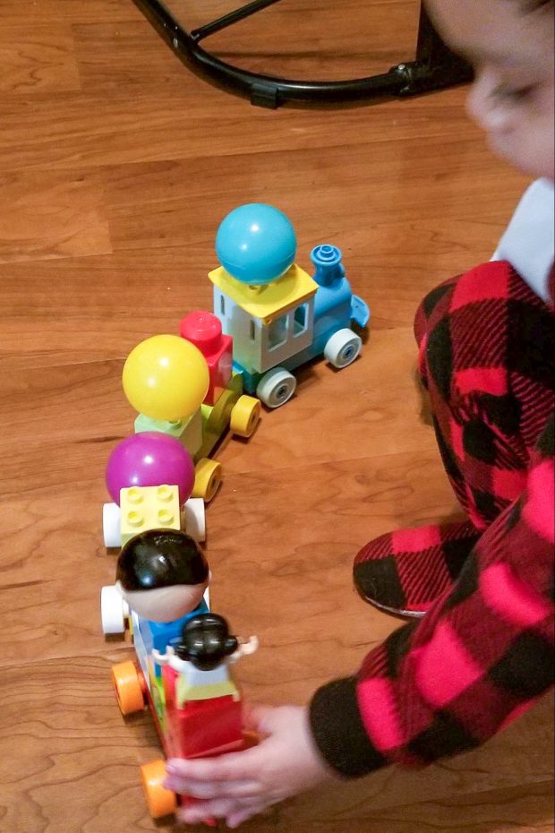 Asiza's son playing with a DUPLO train.
