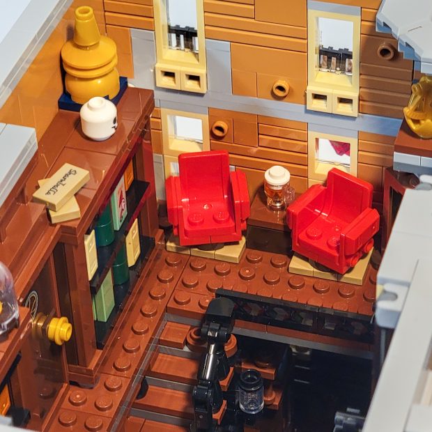 Two comfortable chairs and a beer stein at the top of the stairs.