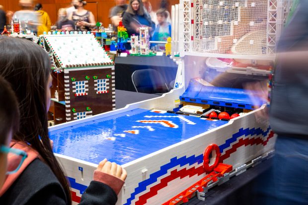 Bre removing the ramp to show how the Skee Ball machine works.