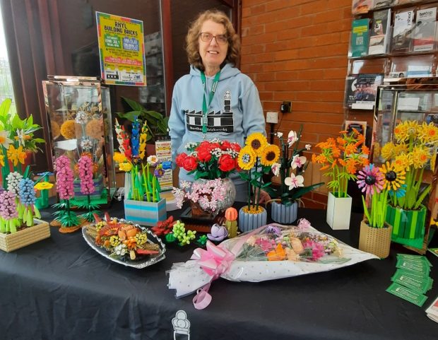 Floss Barrett showcasing her custom LEGO Botanical designs. (Photo: Bricknerd)