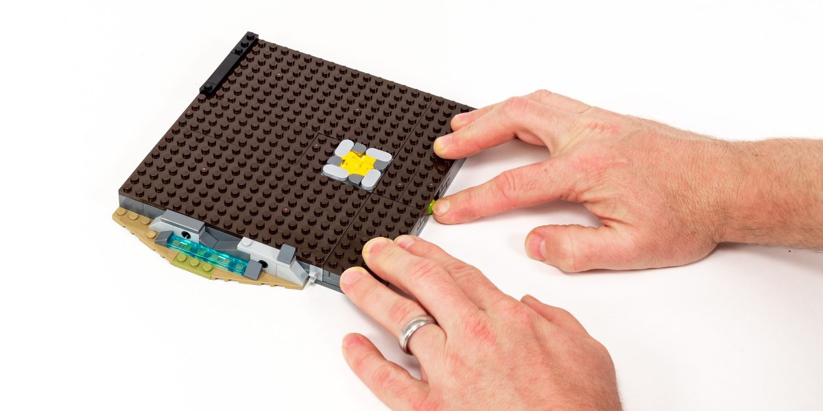 The light brick illuminates when you press the green button on the base.