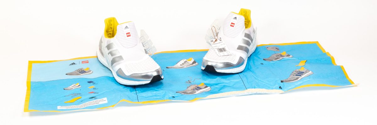 The shoes are wrapped in tissue paper featuring the four steps of the 'build process'.