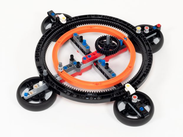 Sturdy base resting on four Technic wheels.