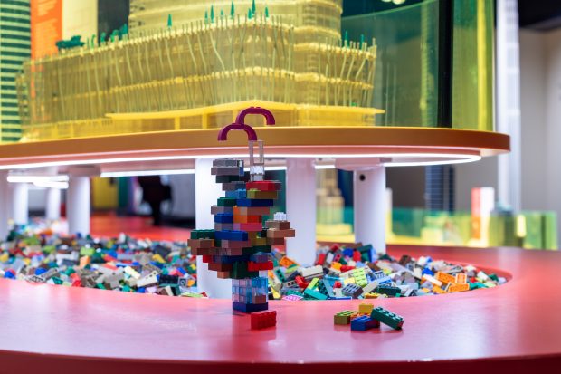 There's space to build your own masterpieces right below these towering LEGO models.