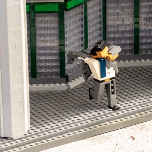 Minilander putting on a suit jacket while running to the train.