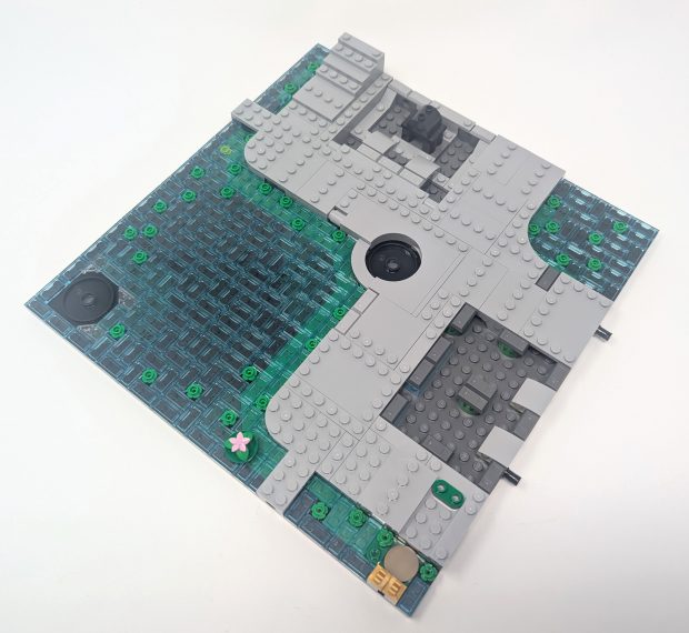 The lifted walkway sits beside the iconic water that covers the base of the Ninjago City sets.