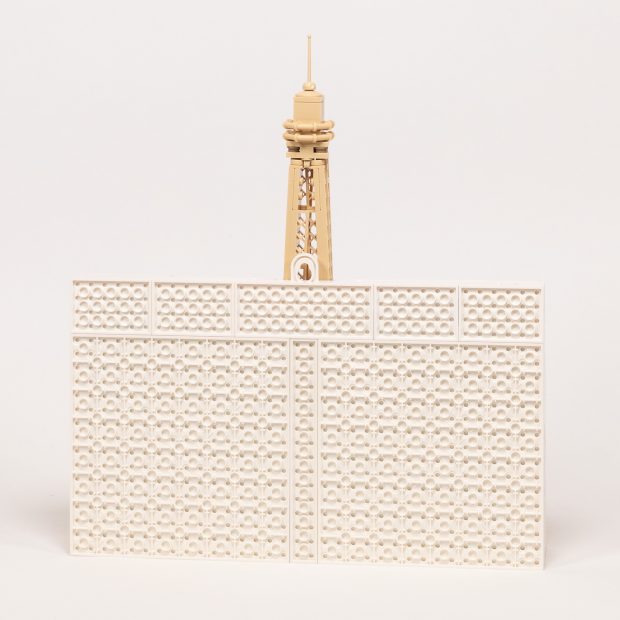 The Eiffel Tower is tall enough to extend well above the frame, and covers the hook to hang it on the wall.